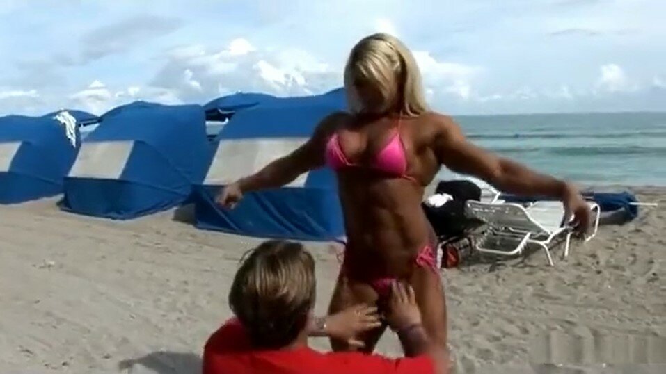 In Between the Legs of a Blonde Muscle Goddess at a Public Beach